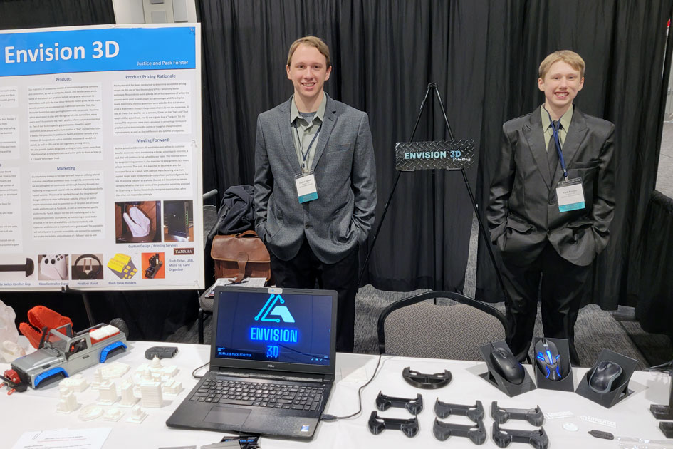 Justice and Pack Forster, student business incubator tenants and owners of Envision 3D, display their business at the Giant Vision Expo.