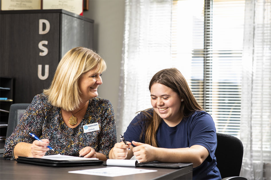 DSU staff member helping a student