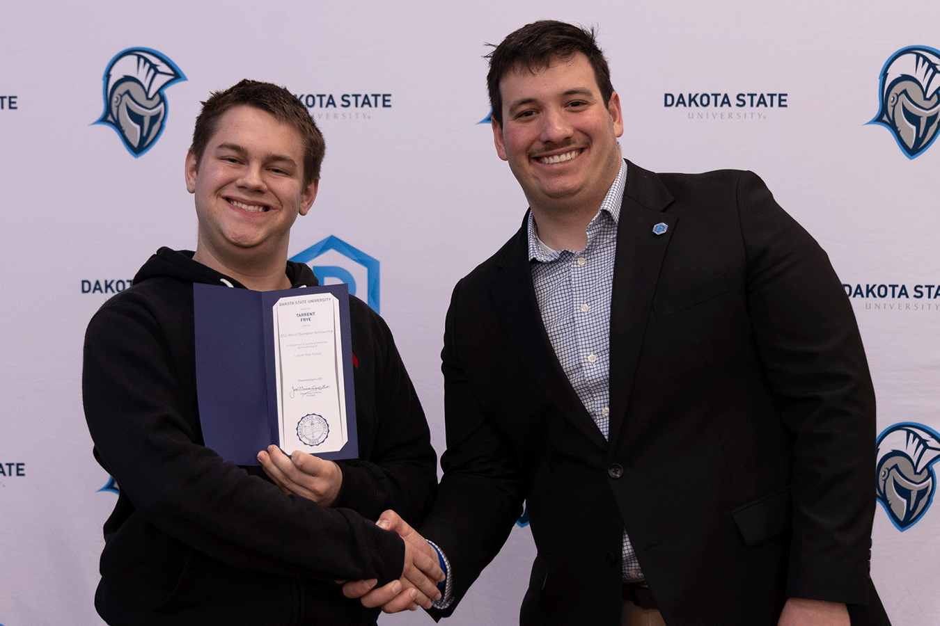 Braxton Lacher congratulates scholarship winners at the 2025 Champion Scholar Registration Day.