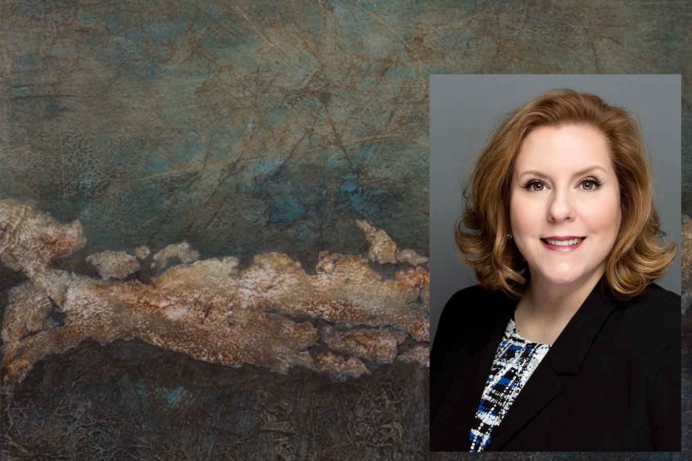 Artist and DSU faculty member Wendy Romero pictured over her artwork