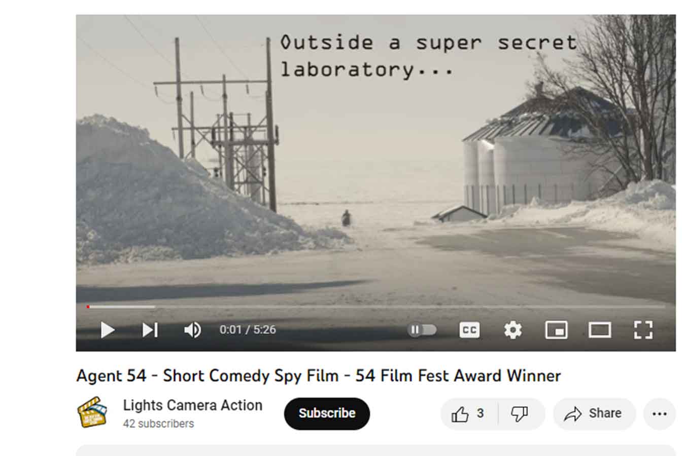 Screenshot of Agent 54, the film, from the LCA Club. It features a figure in the distance running toward the camera in snowy terrain.