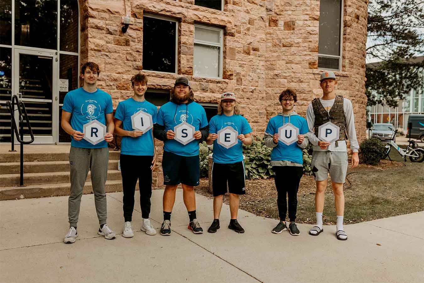 DSU students hold up letters to spell out RISE UP.
