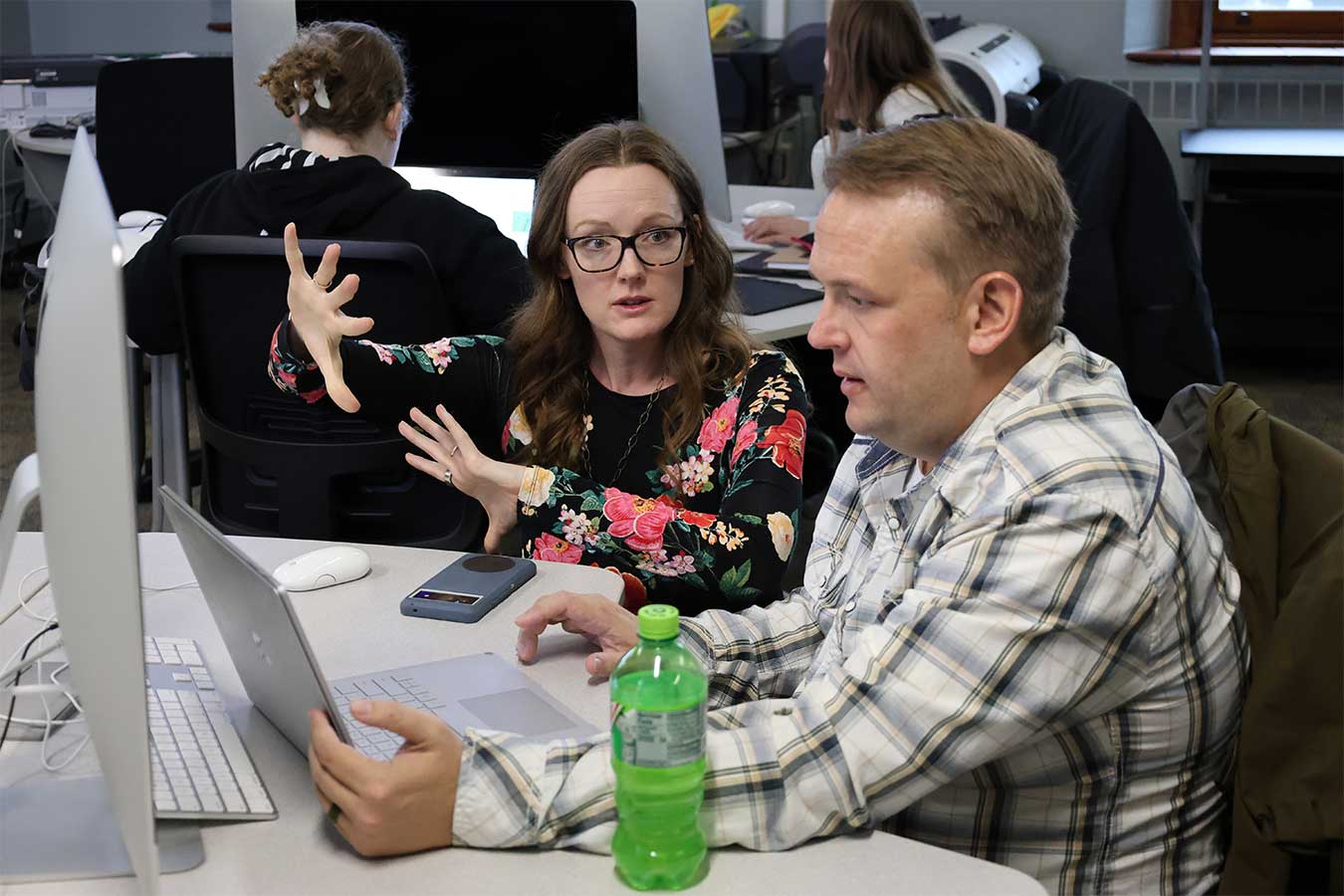 Dr. Haley Larson works with a student in a classroom.
