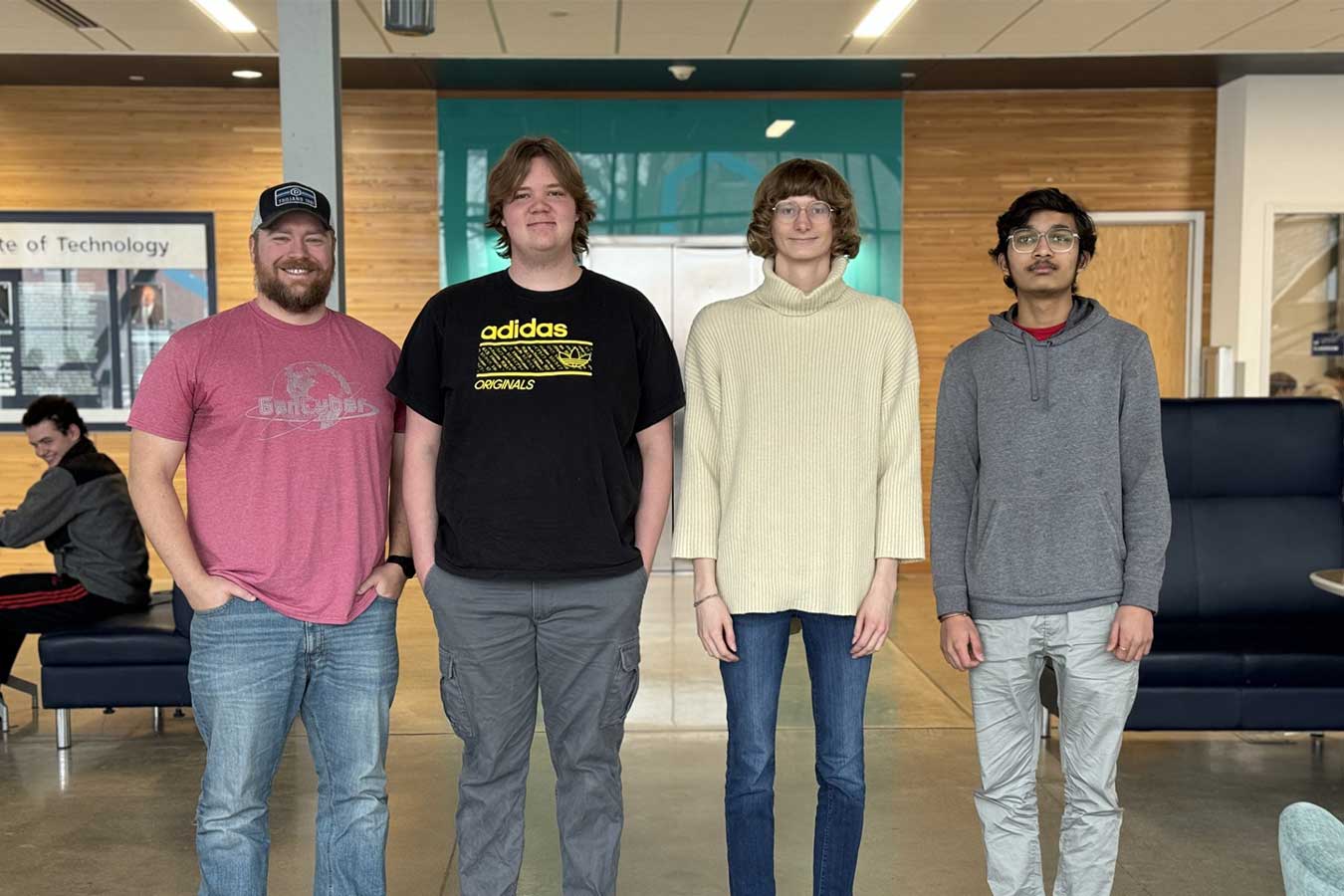 Pictured l-to-r: Coach Dr. Austin O’Brien, with team members Joshua Ganschow, Nora Sandison, and Dax Patel.