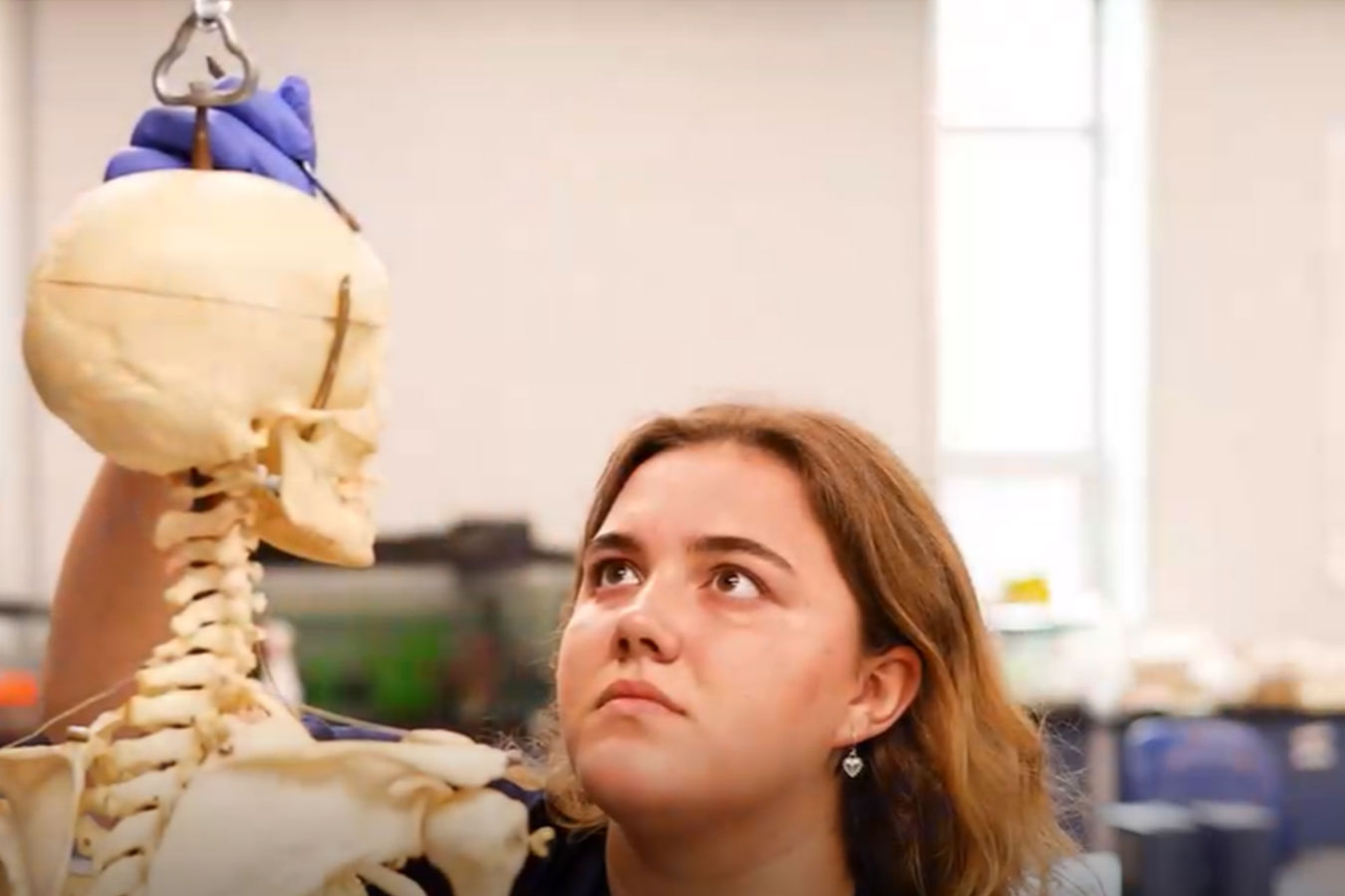 Emme Josko working to restore an educational skeleton at Dakota State University.