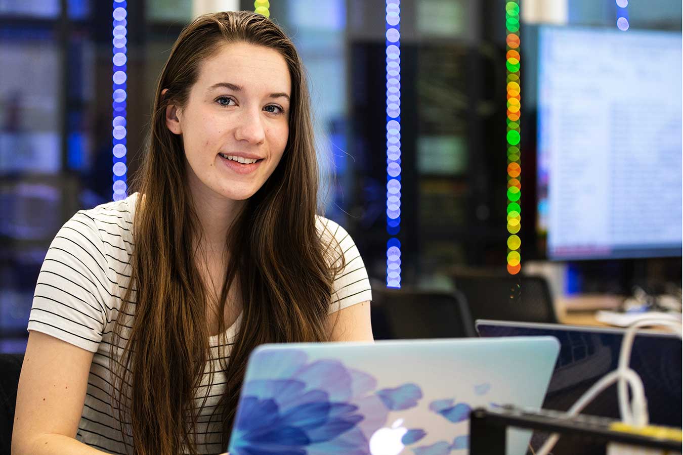 Student sitting at a table in the Beacom Building on campus.