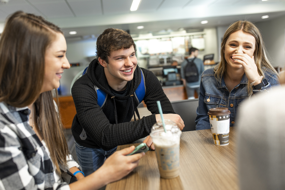 Students drinking coffee at the Trojan Center